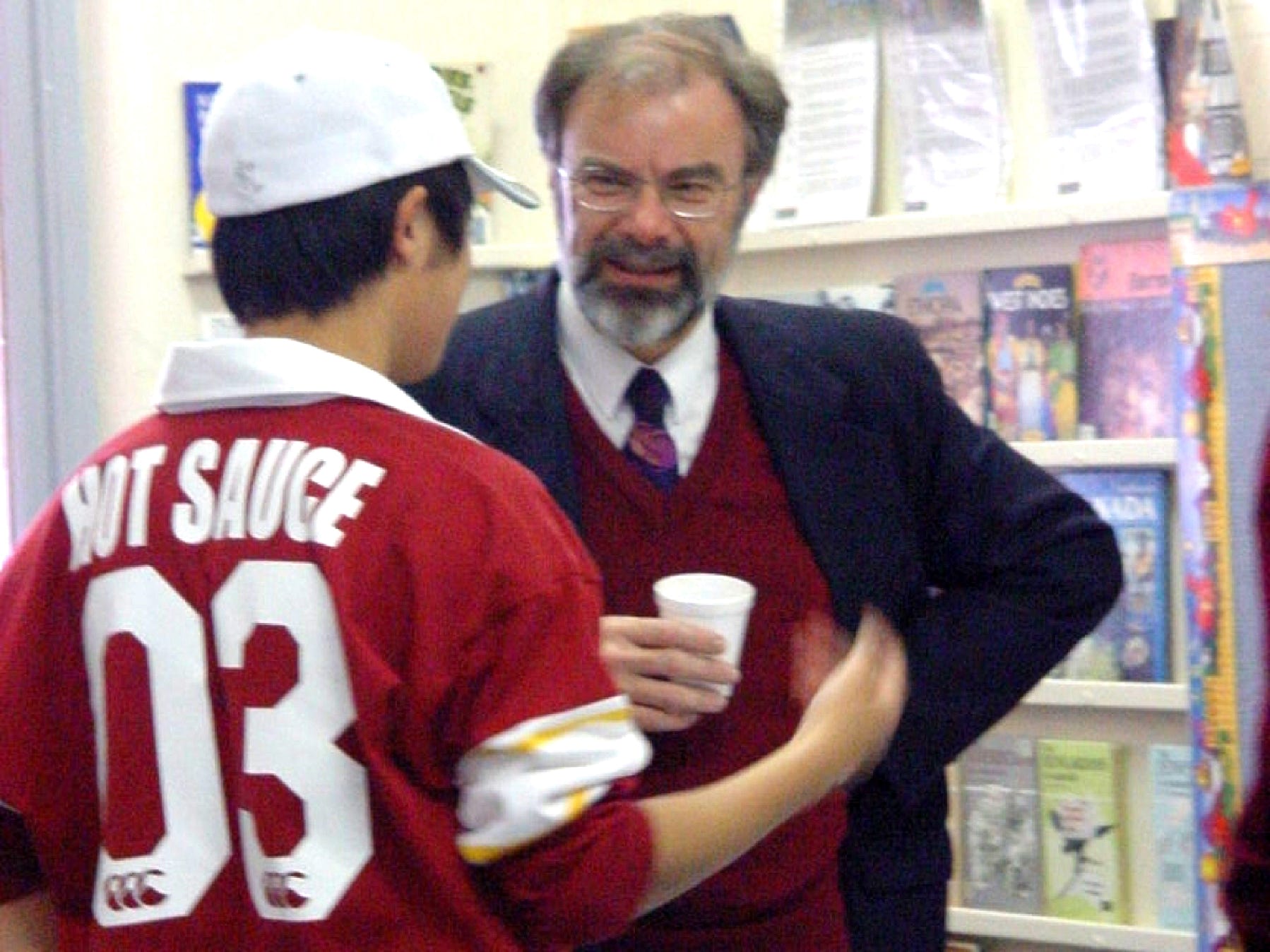 A candid photo of the Principal of Prince Alfred College (Adelaide, Australia), Dr Stephen Codrington, having a conversation with student Jeff Ji, 2003.