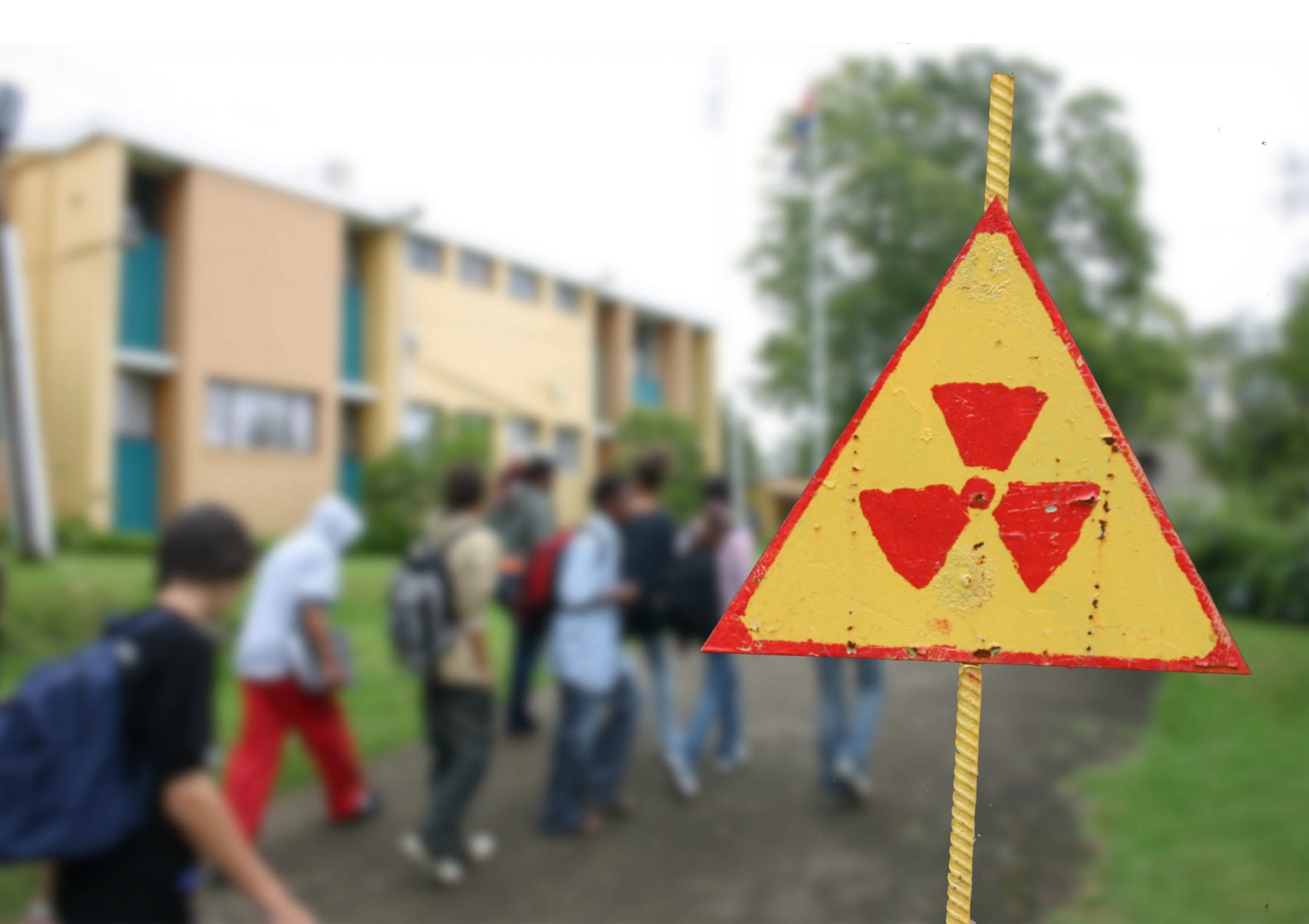 A composite photo showing showing entering a school walking past a sign warning of radioactivity.