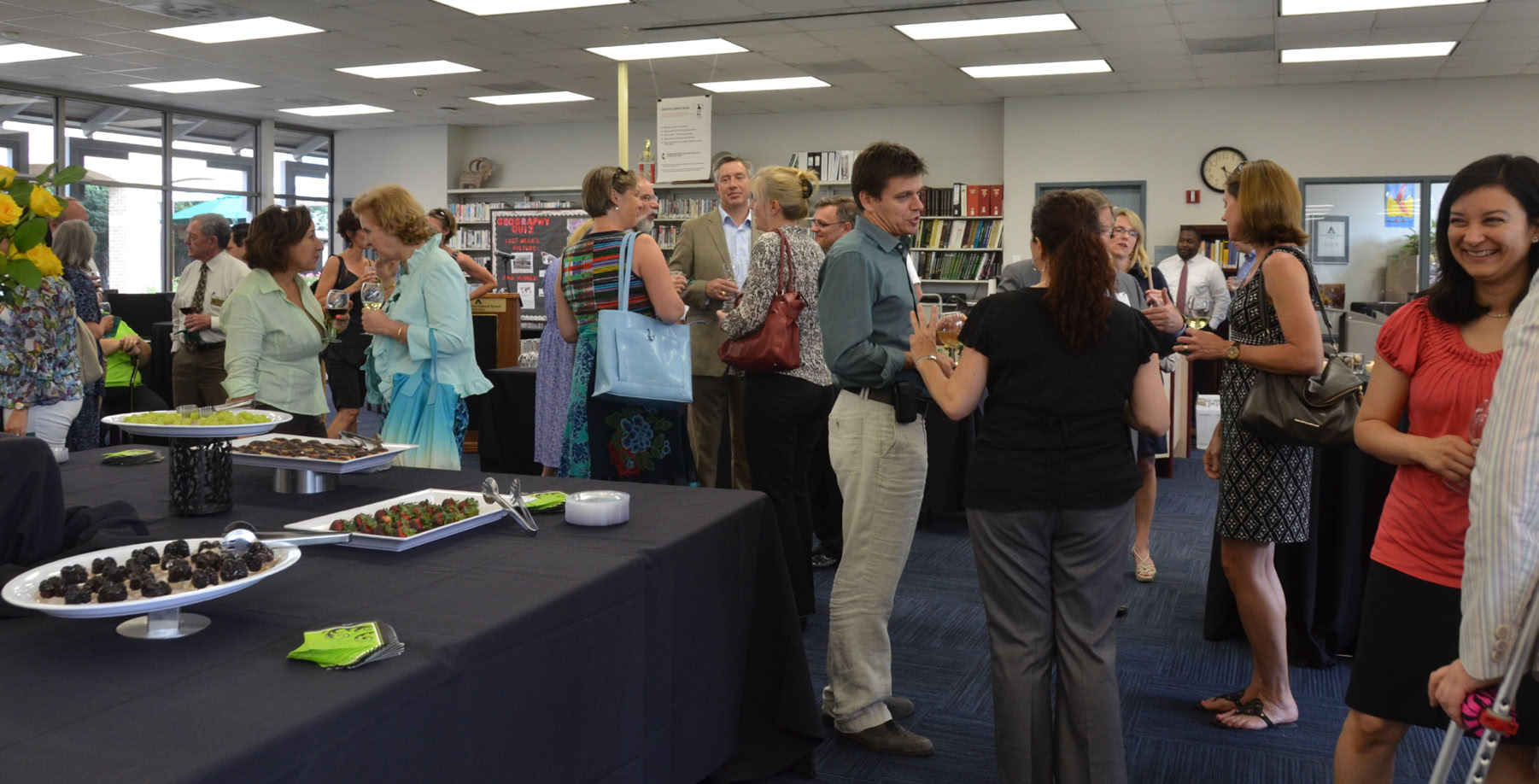 Board members mingle with staff at a social function.