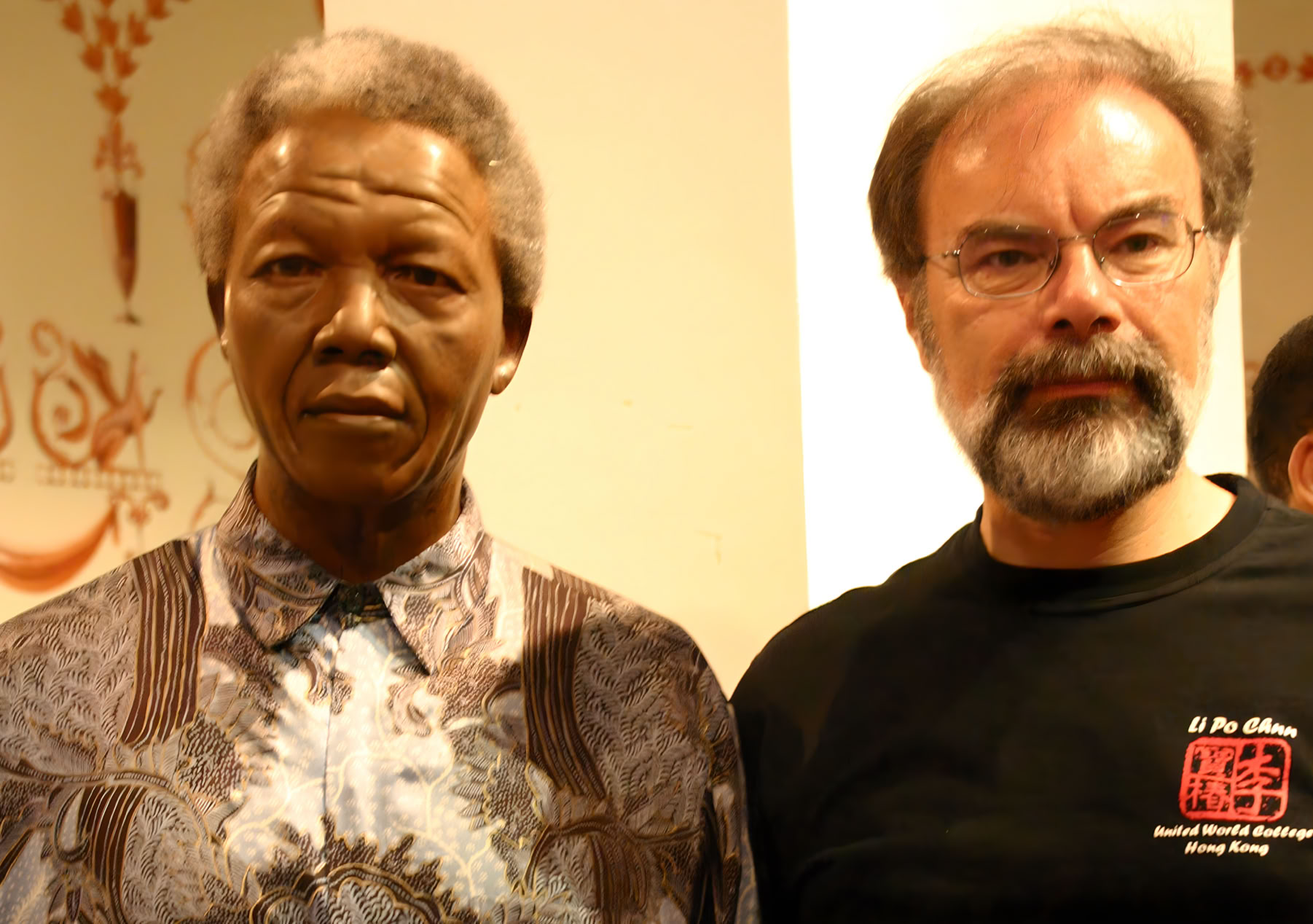 Stephen Codrington stands beside the efficgy of Nelson Mandela at Madama Tussauds in London